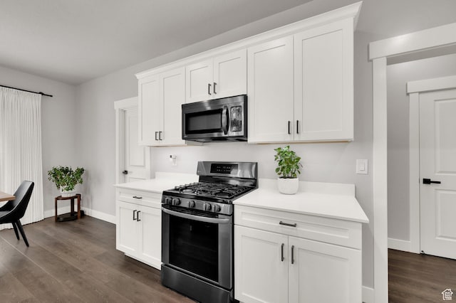 6729 W Dry Peak Dr, Herriman, UT 84096 - kitchen featuring appliances with stainless steel finishes, light countertops, dark wood finished floors, and white cabinets