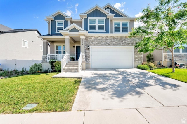 6729 W Dry Peak Dr, Herriman, UT 84096 - craftsman house with a porch, driveway, stone siding, a garage, and stucco siding