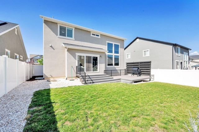 6729 W Dry Peak Dr, Herriman, UT 84096 - rear view of property featuring a fenced backyard, stucco siding, and a deck