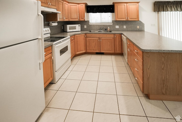 2187 N 3900 W, Plain City, UT 84404 - kitchen with white appliances, under cabinet range hood, a peninsula, light tile patterned floors, and decorative backsplash