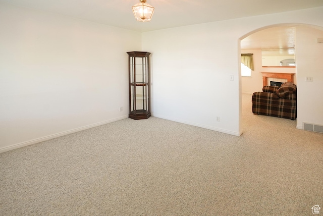 2187 N 3900 W, Plain City, UT 84404 - unfurnished room featuring arched walkways, carpet, and a tiled fireplace