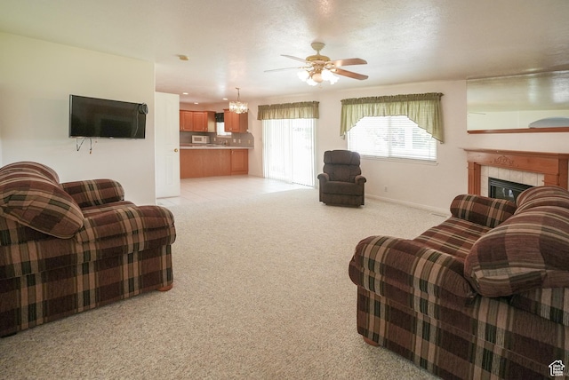 2187 N 3900 W, Plain City, UT 84404 - living area featuring light colored carpet, ceiling fan, a tiled fireplace, and a chandelier