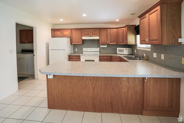 2187 N 3900 W, Plain City, UT 84404 - kitchen featuring white appliances, under cabinet range hood, washer / clothes dryer, a peninsula, and decorative backsplash