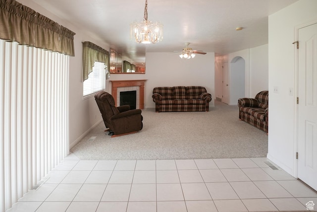 2187 N 3900 W, Plain City, UT 84404 - living area featuring light carpet, ceiling fan, a chandelier, and a tiled fireplace