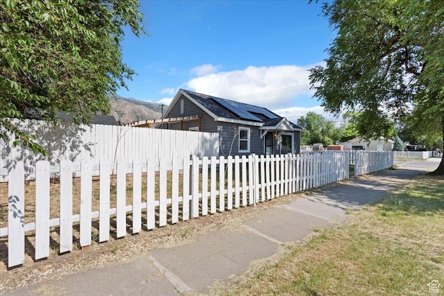 2692 S Monroe Blvd E, Ogden, UT 84401 - view of side of property featuring roof mounted solar panels and a fenced front yard