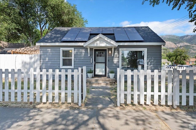 2692 S Monroe Blvd E, Ogden, UT 84401 - view of front of property with solar panels, a fenced front yard, and a mountain view