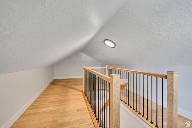 1804 S Park St, Salt Lake City, UT 84105 - corridor with a textured ceiling, an upstairs landing, lofted ceiling, and wood finished floors