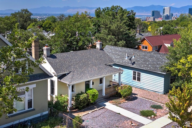 662 E 4th Ave, Salt Lake City, UT 84103 - view of front of house featuring a chimney, a shingled roof, and a mountain view
