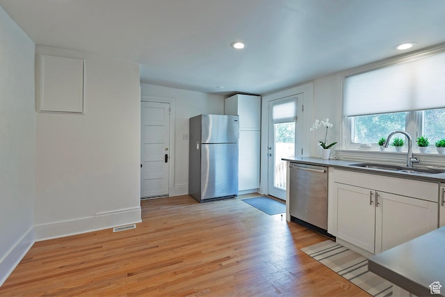662 E 4th Ave, Salt Lake City, UT 84103 - kitchen with stainless steel appliances, white cabinets, light wood-style floors, and recessed lighting