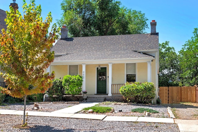 662 E 4th Ave, Salt Lake City, UT 84103 - bungalow-style house featuring a porch, roof with shingles, stucco siding, and a chimney