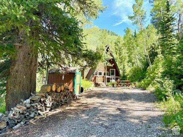10215 E Moose Rd Unit 1, Brighton, UT 84121 - view of front facade featuring a shed and a forest view