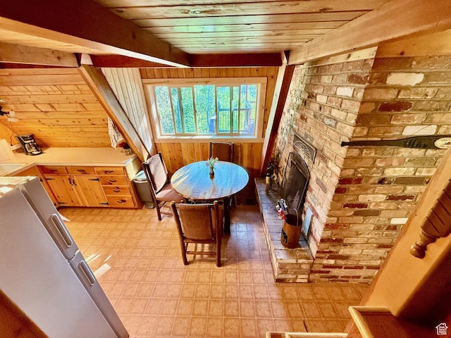 10215 E Moose Rd Unit 1, Brighton, UT 84121 - dining room with wooden walls, brick wall, light flooring, wood ceiling, and a brick fireplace