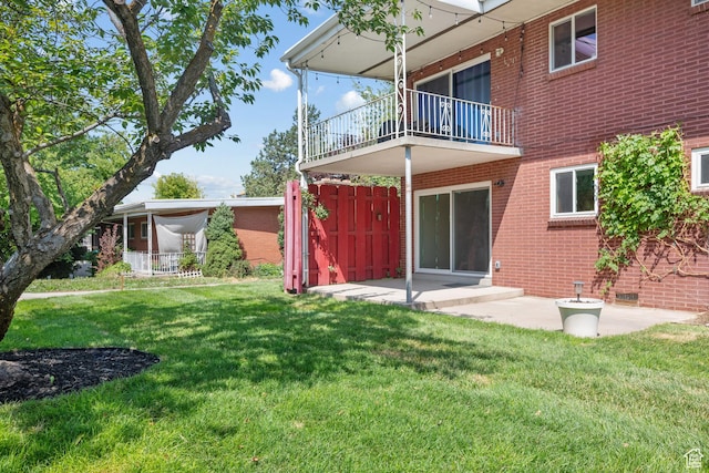 2270 E Murray Holladay Rd S Unit 4, Holladay, UT 84117 - rear view of house with a balcony, a yard, brick siding, and a patio area