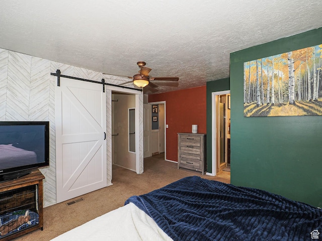 4060 W 2550 S, Taylor, UT 84401 - bedroom featuring carpet floors, a barn door, a textured ceiling, and ceiling fan