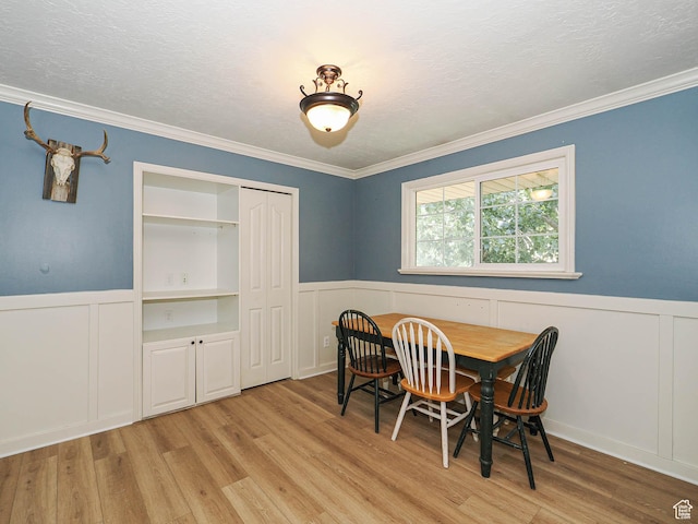 4060 W 2550 S, Taylor, UT 84401 - dining space featuring wainscoting, a decorative wall, light wood-type flooring, and crown molding