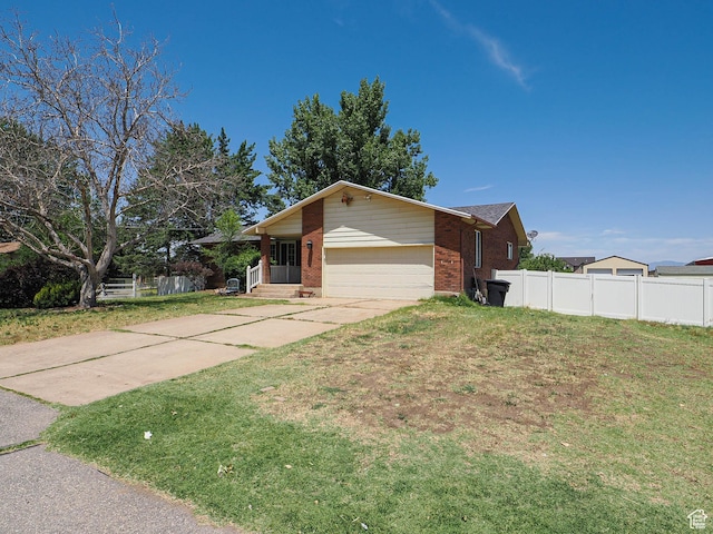 4060 W 2550 S, Taylor, UT 84401 - view of property exterior with brick siding, an attached garage, and driveway