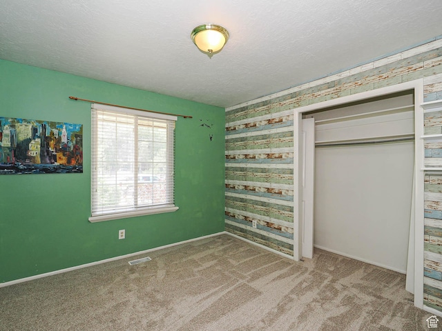 4060 W 2550 S, Taylor, UT 84401 - unfurnished bedroom with carpet flooring, a closet, wallpapered walls, and a textured ceiling