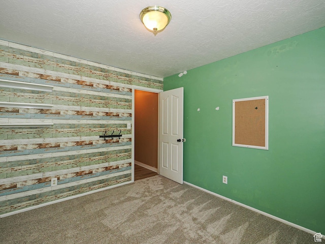 4060 W 2550 S, Taylor, UT 84401 - unfurnished room featuring carpet floors, a textured ceiling, and wood walls