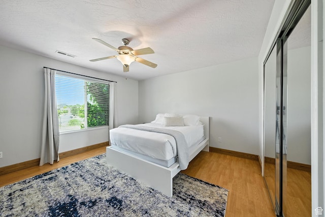 3072 W Current Creek Dr, South Jordan, UT 84095 - bedroom with light wood-style flooring, ceiling fan, and a textured ceiling