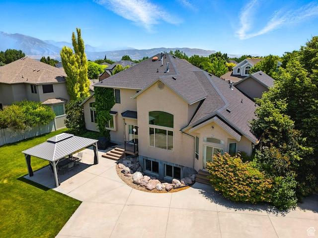 3072 W Current Creek Dr, South Jordan, UT 84095 - view of front of property with a gazebo, a mountain view, a shingled roof, and stucco siding