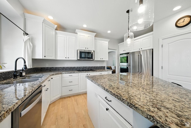 3072 W Current Creek Dr, South Jordan, UT 84095 - kitchen with appliances with stainless steel finishes, recessed lighting, light wood-style floors, light stone countertops, and white cabinets