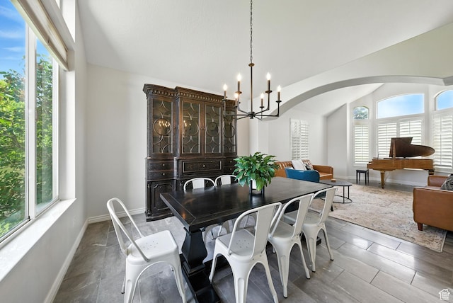 3072 W Current Creek Dr, South Jordan, UT 84095 - dining space with healthy amount of natural light, vaulted ceiling, a chandelier, and arched walkways