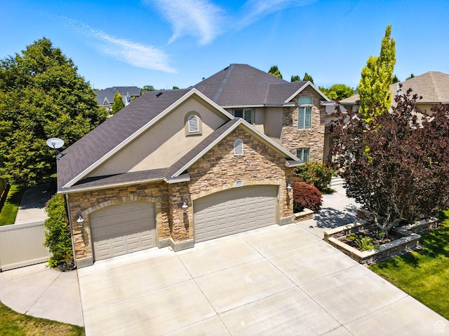 3072 W Current Creek Dr, South Jordan, UT 84095 - view of front of property with stone siding, driveway, stucco siding, and an attached garage