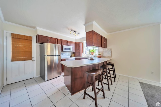 5072 S 1150 E, Ogden, UT 84403 - kitchen featuring white appliances, a peninsula, crown molding, light tile patterned floors, and light countertops