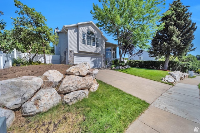5072 S 1150 E, Ogden, UT 84403 - view of front of home featuring a garage, concrete driveway, and stone siding