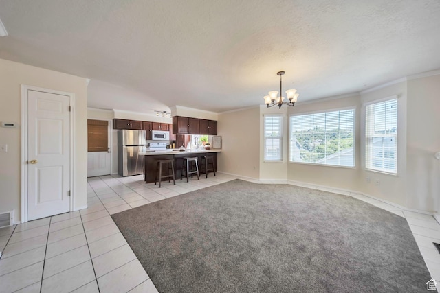 5072 S 1150 E, Ogden, UT 84403 - living room featuring a chandelier, light tile patterned flooring, ornamental molding, and a textured ceiling