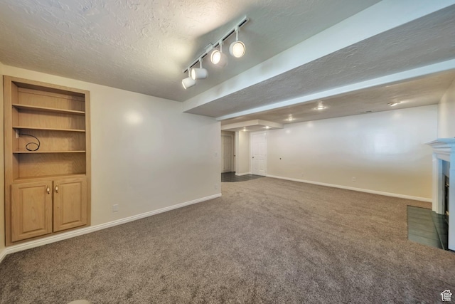 5072 S 1150 E, Ogden, UT 84403 - finished below grade area featuring carpet, a textured ceiling, a fireplace, and built in features