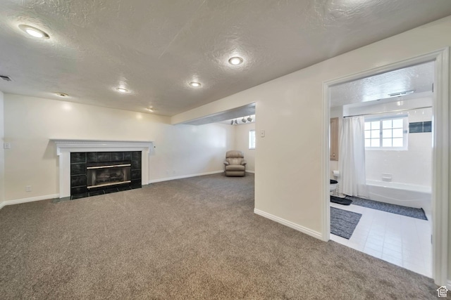 5072 S 1150 E, Ogden, UT 84403 - unfurnished living room with a textured ceiling, carpet floors, a tile fireplace, and recessed lighting