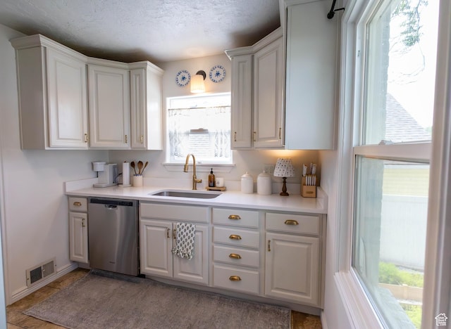 275 N 500 W, Price, UT 84501 - kitchen featuring stainless steel dishwasher, light countertops, and white cabinets