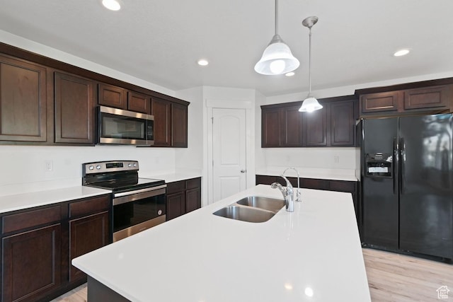 194 N Valcrest Dr, Saratoga Springs, UT 84045 - kitchen featuring appliances with stainless steel finishes, recessed lighting, dark brown cabinetry, hanging light fixtures, and light wood-style floors