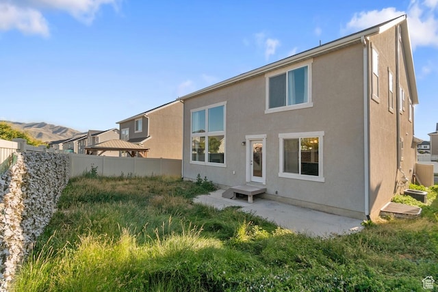 194 N Valcrest Dr, Saratoga Springs, UT 84045 - rear view of house with stucco siding and a patio area