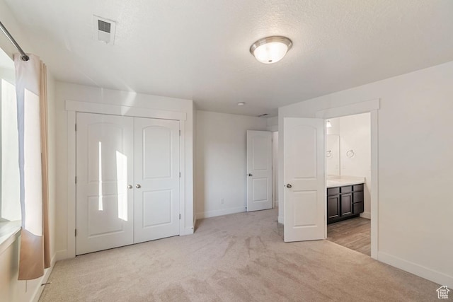194 N Valcrest Dr, Saratoga Springs, UT 84045 - unfurnished bedroom with light carpet, a textured ceiling, a closet, and connected bathroom