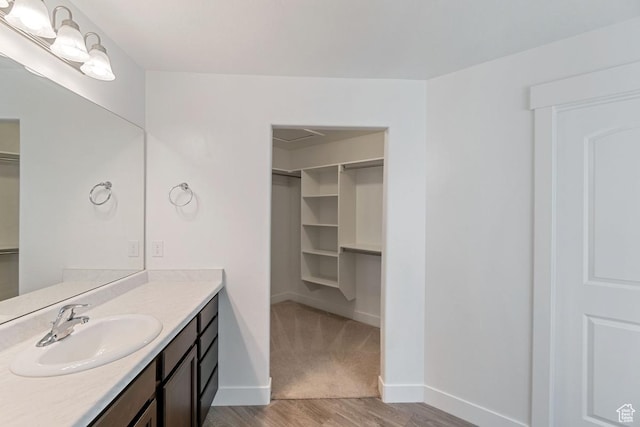 194 N Valcrest Dr, Saratoga Springs, UT 84045 - bathroom with a spacious closet, vanity, and wood finished floors