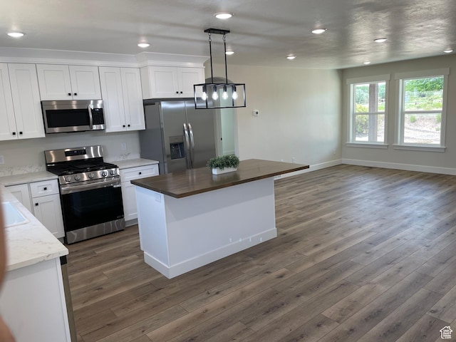 4940 N 5000 W, Roosevelt, UT 84066 - kitchen featuring appliances with stainless steel finishes, dark wood-type flooring, white cabinetry, a kitchen island, and recessed lighting