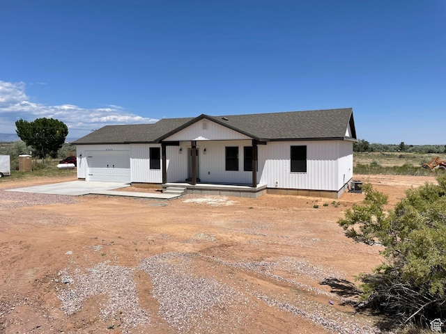 4940 N 5000 W, Roosevelt, UT 84066 - modern farmhouse featuring driveway, an attached garage, roof with shingles, and covered porch