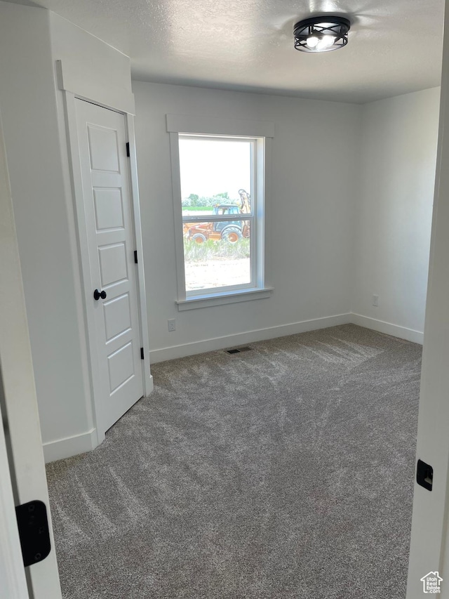 4940 N 5000 W, Roosevelt, UT 84066 - carpeted empty room featuring baseboards and a textured ceiling