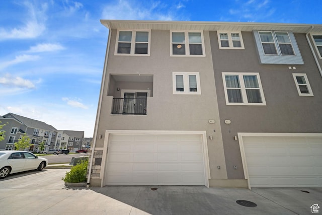 1044 S 2800 E, Spanish Fork, UT 84660 - view of front of home with stucco siding, an attached garage, and a residential view