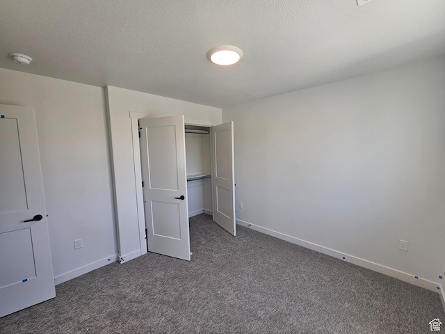2804 W 2710 N Unit 87, Plain City, UT 84404 - unfurnished bedroom featuring carpet flooring, a closet, and a textured ceiling