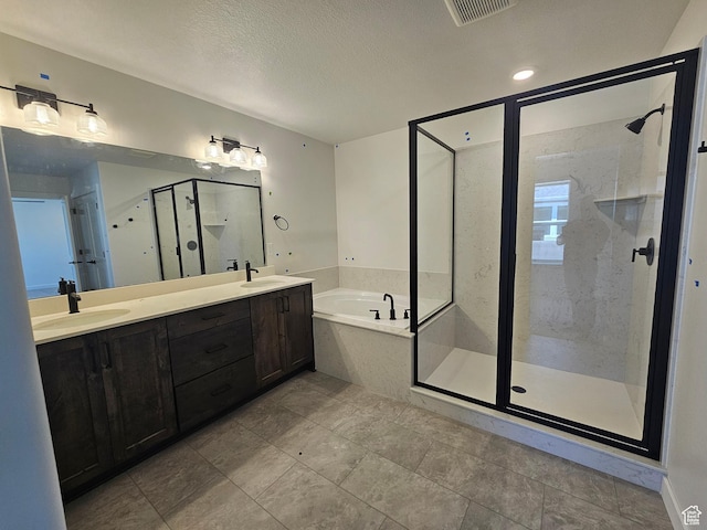 2804 W 2710 N Unit 87, Plain City, UT 84404 - bathroom featuring a bath, a shower stall, double vanity, and a textured ceiling