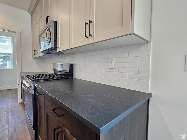 2804 W 2710 N Unit 87, Plain City, UT 84404 - kitchen with appliances with stainless steel finishes, wood finished floors, dark countertops, and backsplash