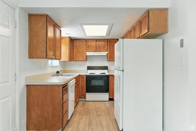 1731 W 800 N, Pleasant Grove, UT 84062 - kitchen with white appliances, under cabinet range hood, light wood finished floors, brown cabinetry, and light countertops