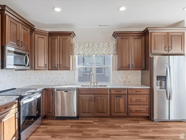 6067 W Whisle Stop Rd S, South Jordan, UT 84009 - kitchen featuring stainless steel appliances, light stone countertops, backsplash, light wood-style flooring, and recessed lighting