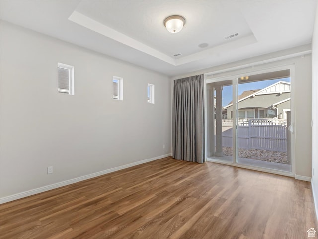 6067 W Whisle Stop Rd S, South Jordan, UT 84009 - unfurnished room featuring a tray ceiling, wood finished floors, and healthy amount of natural light