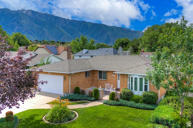 1814 E 9800 S, Sandy, UT 84092 - view of front of property featuring brick siding, a shingled roof, an attached garage, driveway, and a mountain view