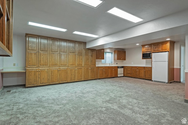 1814 E 9800 S, Sandy, UT 84092 - kitchen featuring white appliances, brown cabinetry, light countertops, light colored carpet, and recessed lighting
