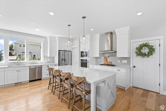 10262 N Yorkshire Cir, Highland, UT 84003 - kitchen with wall chimney exhaust hood, stainless steel appliances, light countertops, decorative backsplash, and recessed lighting
